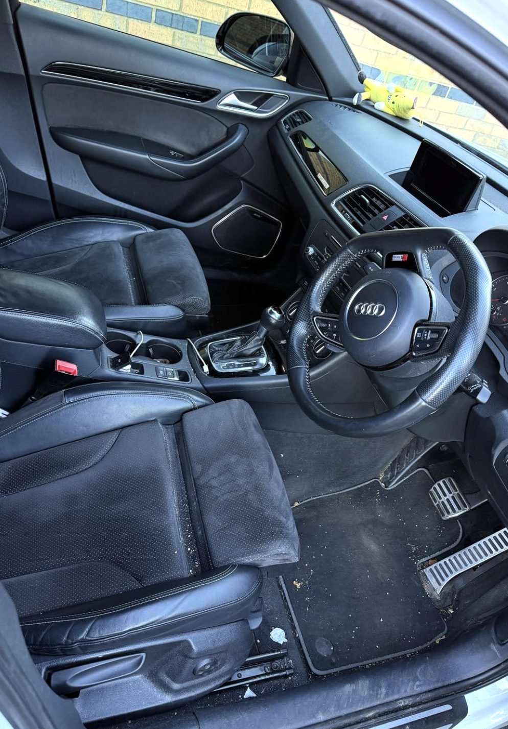 Car interior before valeting — dirty carpets and dusty trim